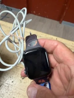 A smartwatch with its charging cable photographed before it was hidden