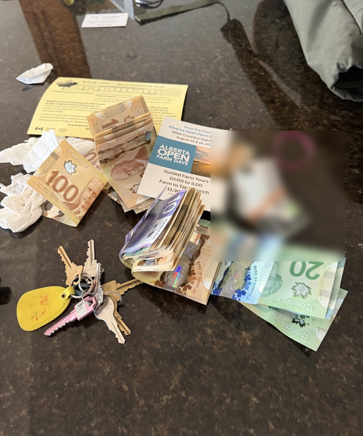 Tim's pocket contents — the cash stack, elastic-band ID bundle, and keychain — photographed just before the tour